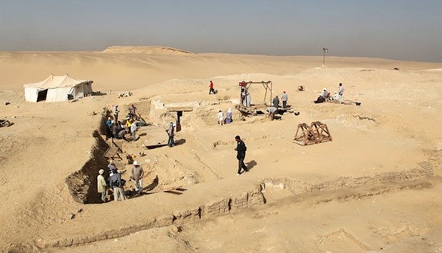 A handout picture released by the Egyptian Ministry of Antiquities on February 1, 2016 shows workers at the site where Czech archaeologists discovered an ancient funerary boat in the Old Kingdom necropolis of Abu Sir, southwest of the capital Cairo.
