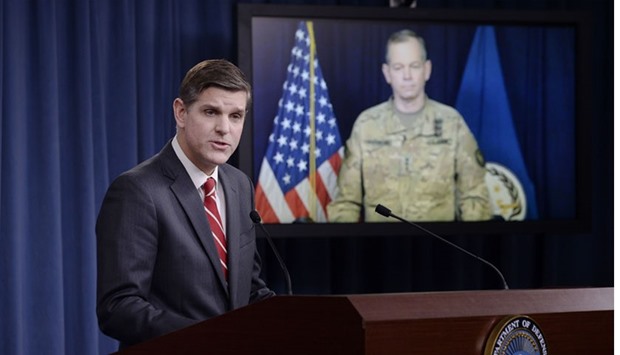 Pentagon Press Secretary Peter Cook speaks as Combined Joint Task Force Commander Army Lt. Gen. Sean MacFarland listens via teleconference from Baghdad, Iraq during a media briefing at the Pentagon to update operations on Operation Inherent Resolve in Arlington, Virginia.
