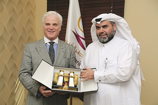 Qatar Charity CEO Yousef bin Ahmed al-Kuwari presents a memento to Minister of State at the Department of International Development Desmond Swayne.