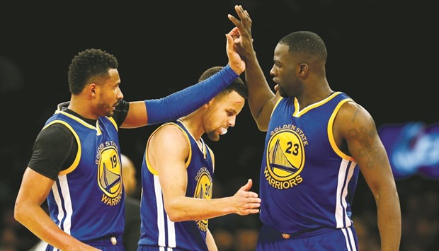 Leandro Barbosa #19, Stephen Curry #30 and Draymond Green #23 of the Golden State Warriors celebrate in the second half against the New York Knicks at Madison Square Garden. Warriors won the game 116-95.