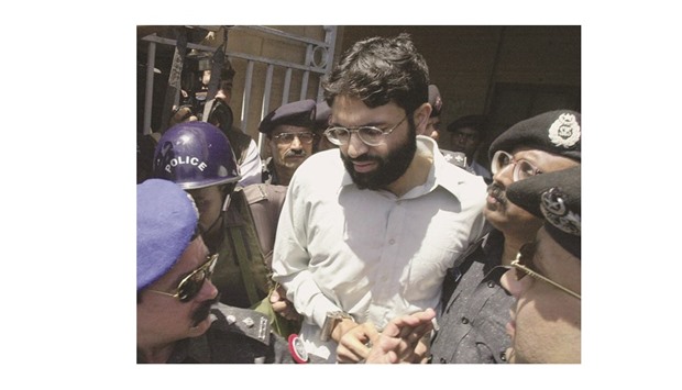 In this file photograph, police surround Ahmed Omar Saeed Sheikh, currently on death row for the murder of US journalist Daniel Pearl, as he leaves a court in Karachi.