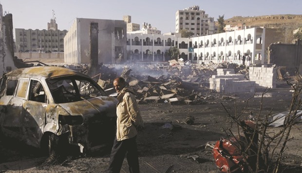 A man examines damages at an amusement park after it was hit by air strikes in Yemenu2019s capital Sanaa.