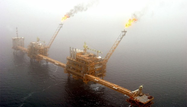 Gas flares from an oil production platform at the Soroush oil fields, 1,250 km south of Tehran from this July 25, 2005 file photo.