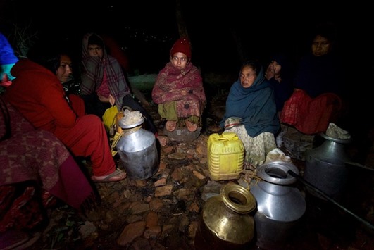 Sita Giri and other women wait to fill water pots. Their main water source dried up after last Aprilu2019s earthquake.