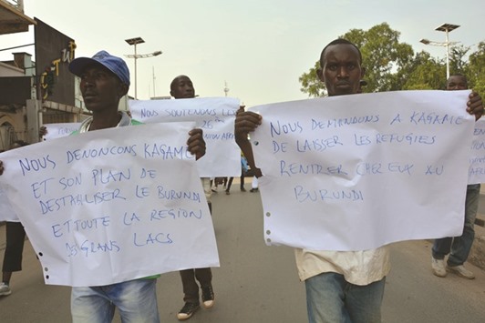 Demonstrators hold signs reading u201cWe ask Kagame to let the refugees come back home to Burundiu201d and u201cWe denounce Kagameu2019s attempt to destabilise Burundi and the Great Lakes regionu201d during a protest in front of the Rwandan embassy in Bujumbura.