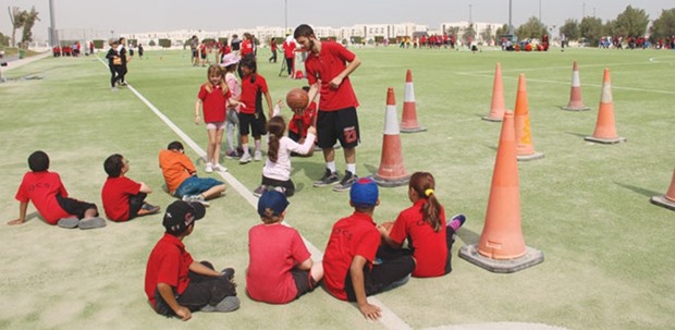 Children participate in one of the CNA-Q activities marking National Sport Day.