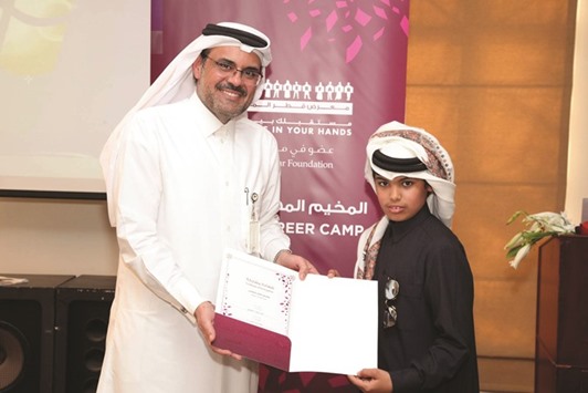 A participant receives his certificate from Abdulla al-Mansoori.