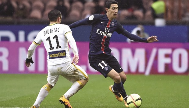 PSGu2019s Angel Di Maria (R) vies for the ball with Lilleu2019s Eric Bautheac during the Ligue 1 match at the Parc des Princes stadium in Paris yesterday. (AFP)