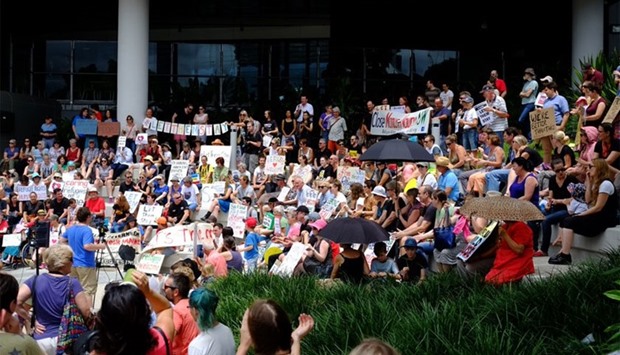Hundreds of people have rallied in front of a Brisbane hospital to support doctors who are refusing to discharge a baby to prevent her from being sent back to immigration detention in Nauru.