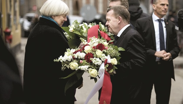 Danish Prime Minister Lars Lokke Rasmussen speaks to Bodil Uzan, mother of Dan Uzan, in Copenhagen.