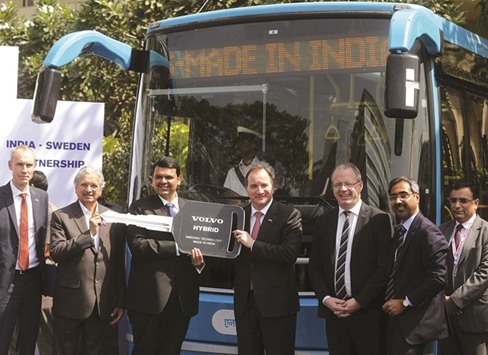 Swedenu2019s Prime Minister Stefan Lofven (4th right) and Maharashtra Chief Minister Devendra Fadnavis (3rd left) pose in front of a Volvo hybrid bus at its launching ceremony during u2018Make in Indiau2019 week in Mumbai yesterday. Even as the Make in India hype scales new heights, some bosses question Modiu2019s delivery on promises to make it easier to do business, while marketing experts caution against creating unrealistic expectations.