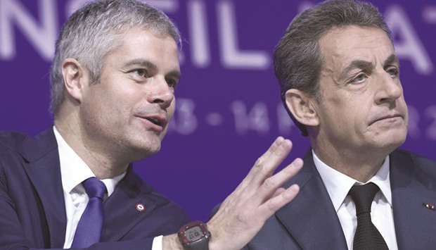 French right-wing Les Republicains (LR) party president Nicolas Sarkozy (right) and delegate vice-president Laurent Wauquiez attend the LR National Council in Paris yesterday.