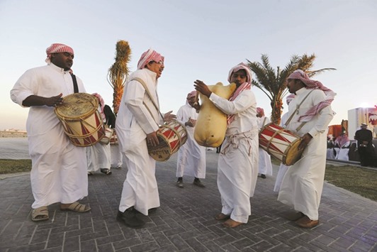 Local folk performers play Bahraini traditional music as they dance celebrating the 15th anniversary of National Charter Day in the Sitra Park south of Manama yesterday.