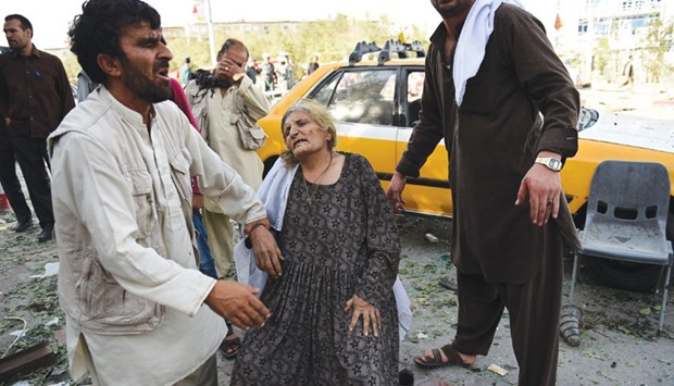 A file picture taken on August 22, 2015 shows Afghan residents reacting as they search for relatives at the site of a car bomb in Kabul.