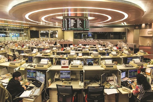 Traders at the Hong Kong Stock Exchange. The Hang Seng index jumped 2.7% to 18,819.59 points yesterday.