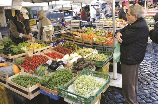 A man looks on at the local market in downtown Rome. Italyu2019s public finance difficulties are deepening as its economy weakens, and it may be punished by the markets even if Prime Minister Matteo Renzi reaches a compromise with the European Commission in a dispute over this yearu2019s budget.