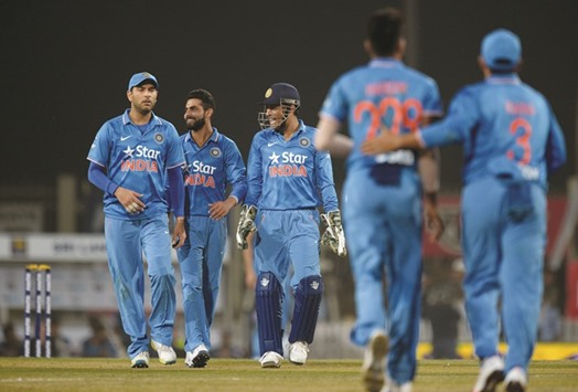File picture of Indiau2019s T20 cricket captain Mahendra Singh Dhoni (C) celebrating with teammates during the second T20 against Sri Lanka in Ranchi.