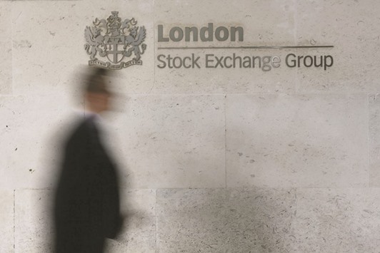 A man walks past the London Stock Exchange in the City of London. European stock markets pushed sharply higher yesterday with London closing 2% higher.
