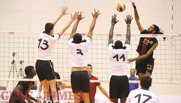 Al Rayyan player (in black and red) goes for a smash against Al Sadd during their Qatar Volleyball League match at Al Arabi Indoor Hall yesterday. Al Rayyan won the match 3-1 (25-12, 22-25, 25-19, 25-23). PICTURE: Jayaram