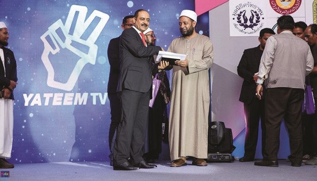 Qataru2019s ambassador to Thailand Jabor bin Ali al-Dosari presenting a prize at the event in Bangkok.