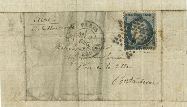 The photo of the tiny letter from a man to his mother flown out of Paris by hot air balloon during the Prussian siege and which has turned up in Australia's National Archives, saying it was keen to know the family's fate.  AFP