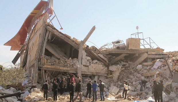 People gathering around the rubble of a hospital supported by Doctors Without Borders (MSF) near Maaret al-Numan, in Syriau2019s northern province of Idlib, yesterday after the building was hit by suspected Russian air strikes.