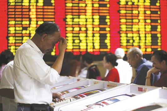Investors look at computer screens showing stock information at a brokerage house in Shanghai. The Shanghai composite closed up 3.3% at 2,836.57 points yesterday.