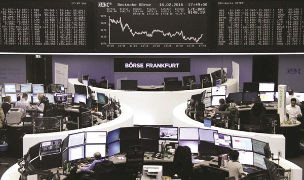 Traders work at the Frankfurt Stock Exchange. The DAX 30 closed down 0.8% at 9,135.11 points yesterday.