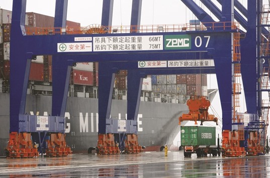 A container is prepared prior to being loaded on a ship at the Port of Taipei in Bali Township. Taiwanu2019s exports in January dropped by 13% to $22.2bn from $25.5bn a year ago.