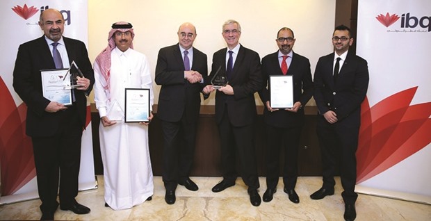 IBQ officials with the banku2019s latest accolades from The Banker Middle East Qatar Product Awards.