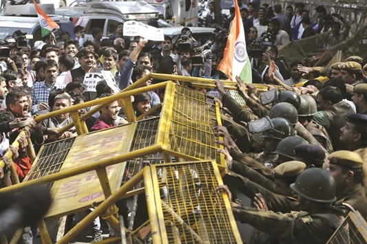 Police stop activists from various Hindu rightwing groups as they try to cross a barricade during a protest against the students of Jawaharlal Nehru University (JNU) outside the campus in New Delhi yesterday.