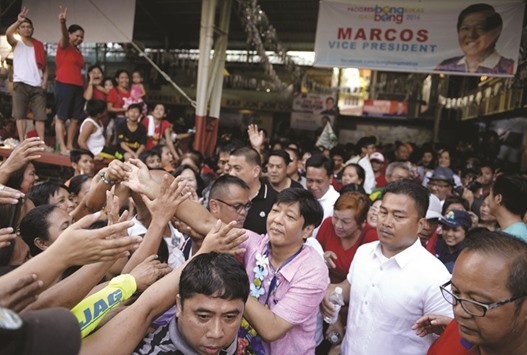 Vice-presidential candidate Ferdinand Marcos Jr, the son of late dictator Ferdinand Marcos, shakes hands with his supporters during a campaign rally in Manila yesterday.