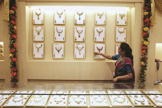 A woman arranges gold necklaces at a jewellery shop in Mumbai. While global investors have piled into gold as a haven from financial turmoil in 2016, the metalu2019s best start to the year in more than three decades has tempered the enthusiasm of buyers in India.