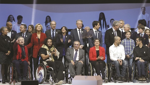 Officials and athletes pose on stage at the end of  the official presentation of Paris as candidate for the 2024 Summer Olympic Games, in Paris yesterday. Among those present at the ceremony were former sprinter Stephane Diagana, French National Olympic and Sports Commitee president Denis Masseglia, former slalom canoeist and member of the French Olympic committee Tony Estanguet, and Guy Drut, former sprinter and member of the French Olympic committee. (AFP)