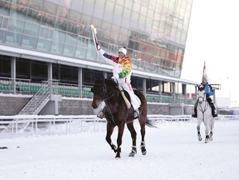 In this December 21, 2013, picture, a torchbearer rides a horse in Ufa, about 1200 kms east of Moscow. Since a WADA report late last year detailing systematic doping in Russia, the Moscow lab has lost its certification while Russian track and field athletes have been banned from competing.