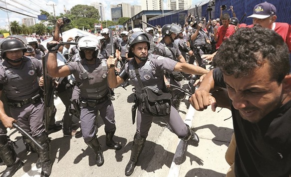 Riot policemen clash with members of the Workersu2019 Party (PT) after the public ministry suspended a hearing at which former Brazil president Luiz Inacio Lula da Silva was to be questioned over corruption allegations, in Sao Paulo, Brazil, yesterday.