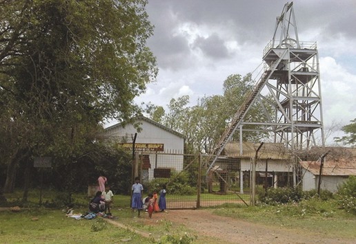 Schoolchildren play in front of an abandoned shaft at Kolar Gold Fields, located in the southern state of Karnataka in this September 9, 2011 file photo. India is planning to auction at least three gold mines this year.