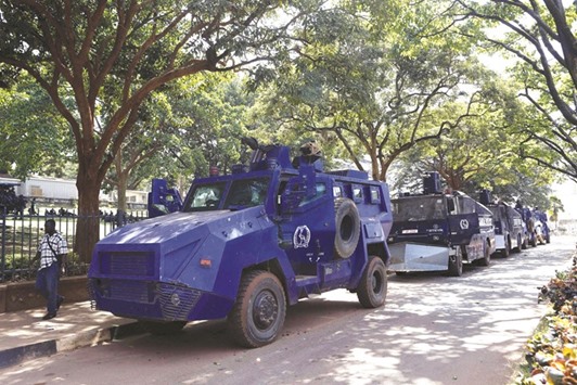 A man walks past armoured police crowd control vehicles parked in Ugandau2019s capital Kampala yesterday ahead of the presidential elections today.