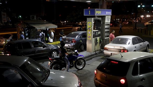 Venezuelan motorists line up for fuel at a gas station, which belongs to Venezuela's state oil company PDVSA, in Caracas.