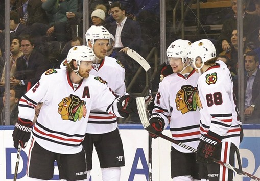 Chicago Blackhawks left wing Artemi Panarin (second from right) is congratulated by his teammates after scoring his third goal of the game for a hat trick against the New York Rangers at Madison Square Garden on Wednesday. (USA TODAY Sports)