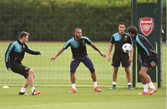 File picture of Arsenalu2019s Theo Walcott (C) training with Mesut Ozil (L).