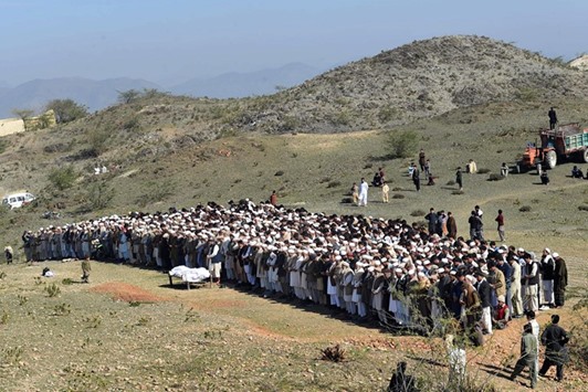 Pakistani tribesmen offer funeral prayers for a policeman who was killed in twin attacks by Taliban militants in Mohmand district yesterday.