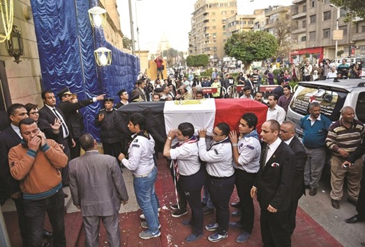 Egyptian scouts carry the coffin of Egyptu2019s former UN secretary-general Boutros Boutros-Ghali during his funeral in the Abassiya district of Cairo yesterday.