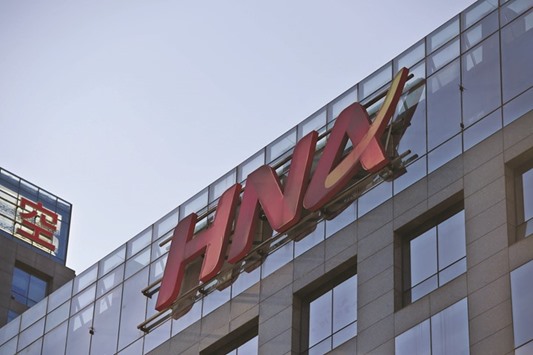 The HNA logo is seen on a building in Beijing. The Chinese conglomerate will pay Ingram Micro $38.90 per share in the takeover deal.