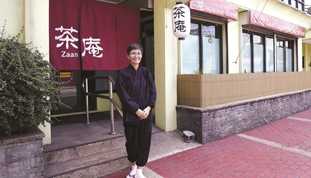Noriko Iwamoto, a Japanese widow and senior citizen, poses outside her restaurant at a residential district in suburban Quezon city, Metro Manila.
