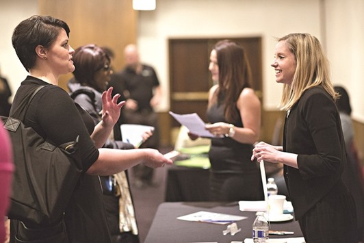 Company representatives talk to job seekers during a job fair in Chicago. Initial claims for state unemployment benefits decreased 7,000 to a seasonally adjusted 262,000 for the week ended February 13, the lowest reading since November, the Labour Department said.