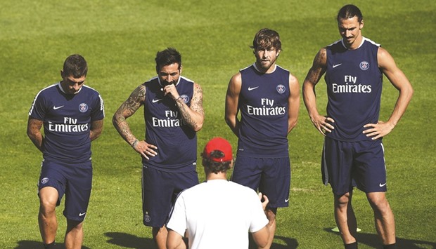 File picture of Paris Saint-Germainu2019s French head coach Laurent Blanc (C) speaking to his players during a training session.
