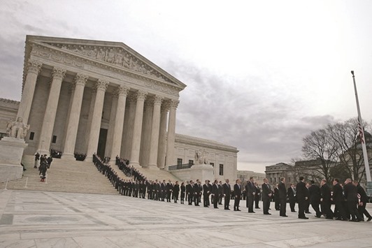The casket of associate justice Antonin Scalia is carried by US Supreme Court police officers up the steps of the Supreme Court building in Washington, DC. Justice Scalia will lie in repose in the Great Hall, where visitors can pay their respects.