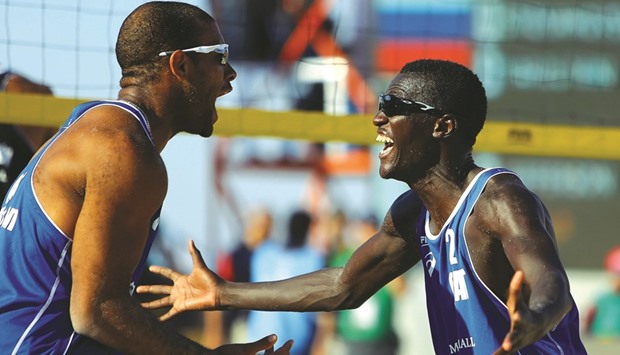 Jefferson Santos (left) and Cherif Younousse celebrate after winning the final of the inaugural Kish Island Open yesterday.