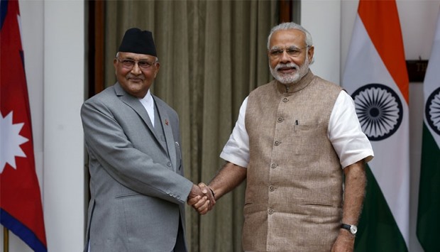 Nepal's Prime Minister Khadga Prasad Sharma Oli (L) shakes hands with his Indian counterpart Narendra Modi during a photo opportunity ahead of their meeting at Hyderabad House in New Delhi